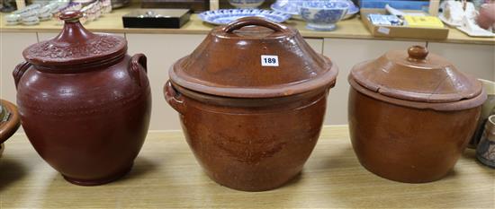 Three late Victorian terracotta cream pans, with wooden covers tallest 33cm
